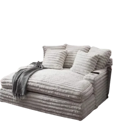 Gray plush sofa with cushions and a blanket on a white background