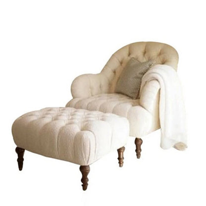 Beige chaise lounge with matching ottoman on a white background