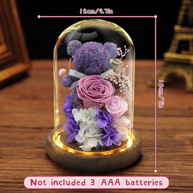 Preserved flower bear displayed on a bedside table.