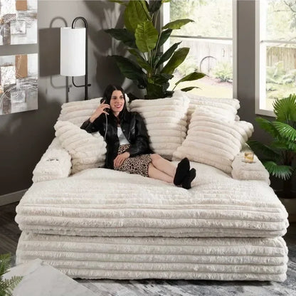 Person sitting on a large, fluffy white sofa in a modern living room.