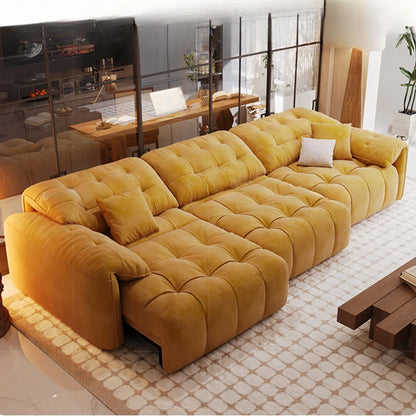 Yellow sectional sofa in a modern living room with a desk and decor.