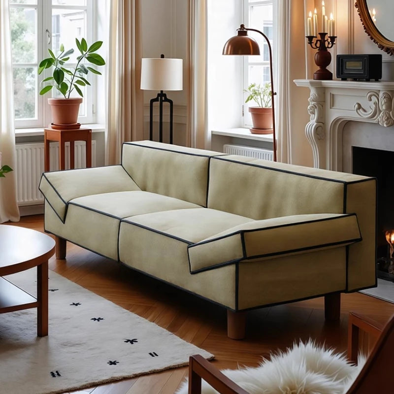 Beige sofa in a living room with wooden floor and decorative elements.