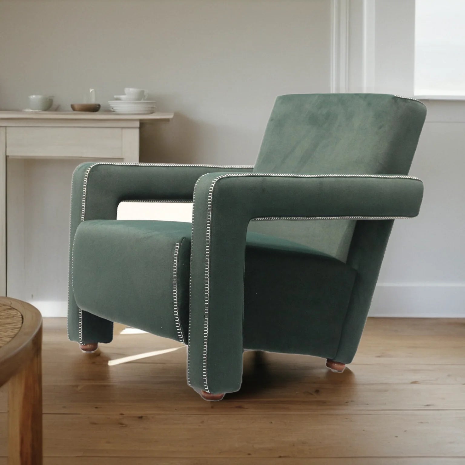 Green armchair in a room with wooden floor and white walls