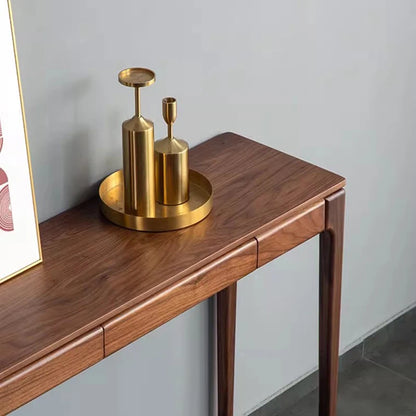 Wooden console table with gold decorative items against a light gray wall.