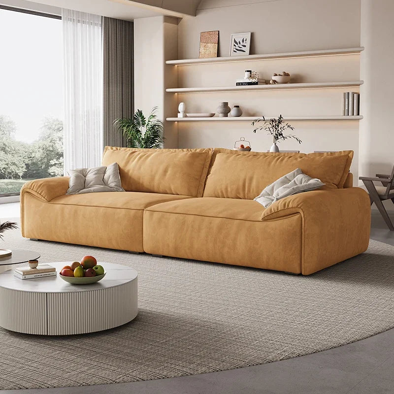 Yellow sofa in a modern living room with shelves and a coffee table.