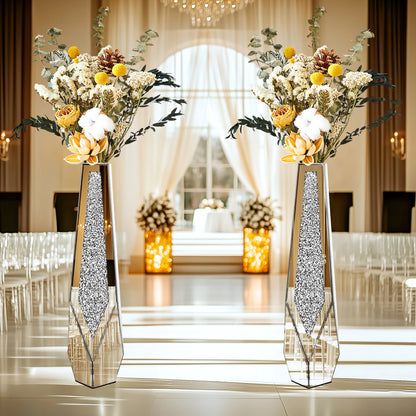 Decorative vases with floral arrangements in a formal event setting.