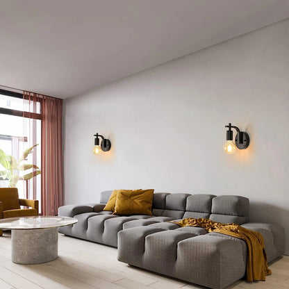 Modern living room with a gray sectional sofa, yellow cushions, and wall lights.