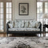 Decorative sofa in a living room with floral pattern and matching pillows.