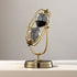 Decorative sand timer with gold frame and clear sand compartments on a neutral background