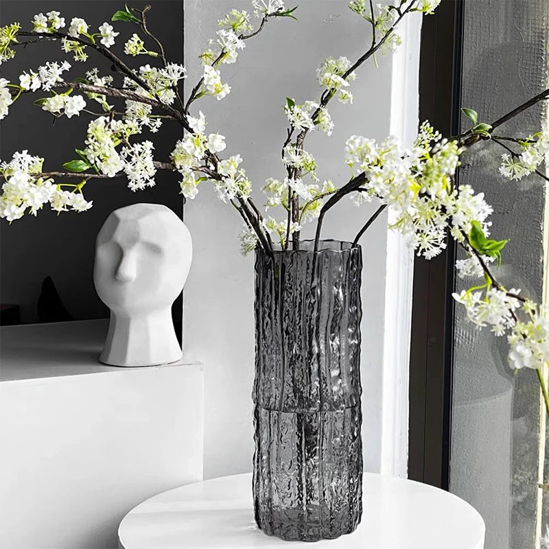 Decorative vase with floral branches on a white surface