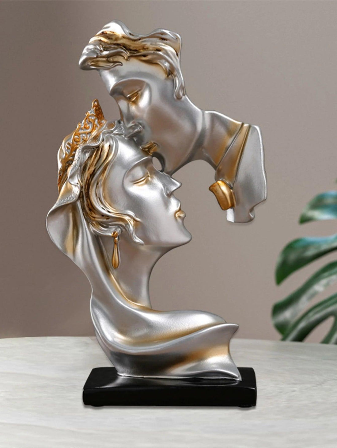 Side view of resin kissing sculpture on a wine cabinet with warm lighting.