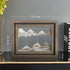 Framed mountain art piece on a shelf with dimensions indicated