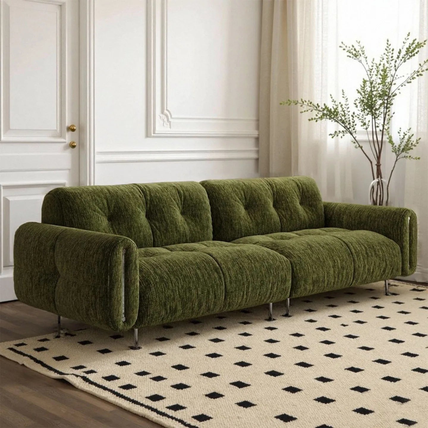 Green sofa in a room with a patterned rug and decorative elements.