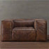 Brown leather sofa against a gray wall