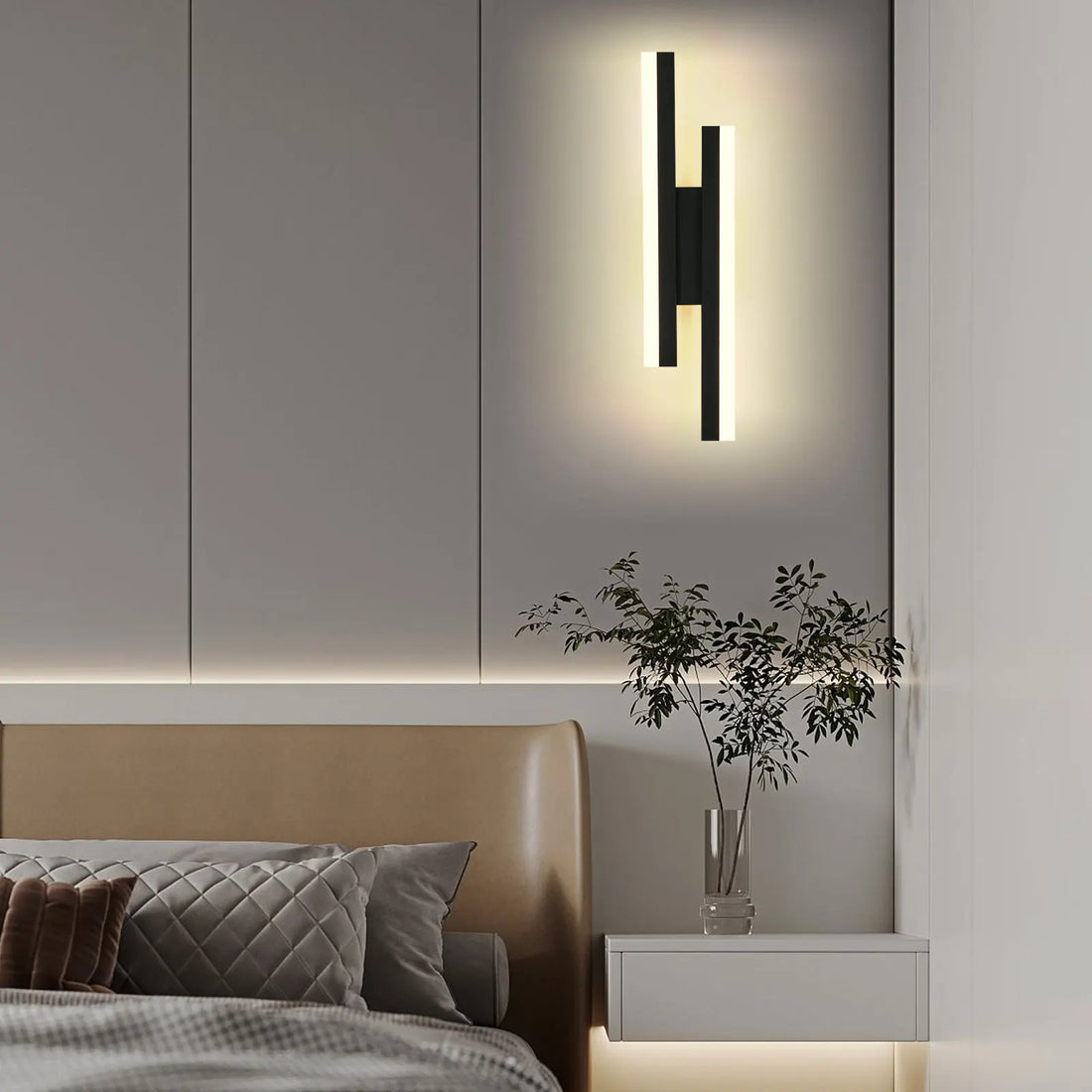 Modern wall sconce above a bed in a bedroom setting