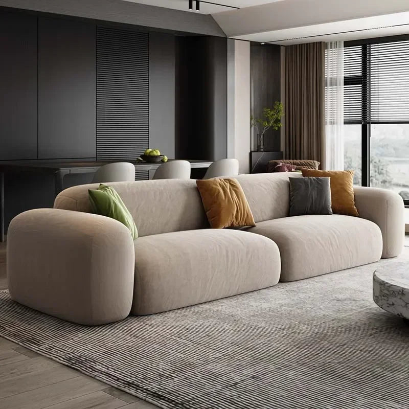Modern living room with a beige sofa and decorative pillows.