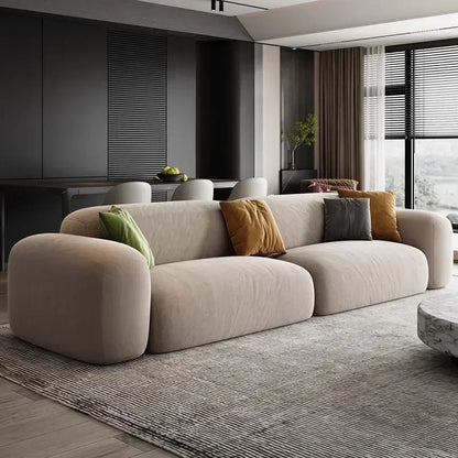 Modern living room with a beige sofa and decorative pillows.