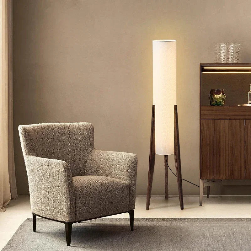 Modern armchair in a room with a floor lamp and wooden cabinet.