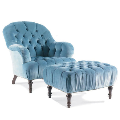 Blue velvet armchair with matching ottoman on a white background