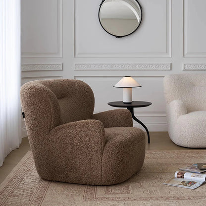Brown textured armchair in a stylish room with a mirror and lamp.