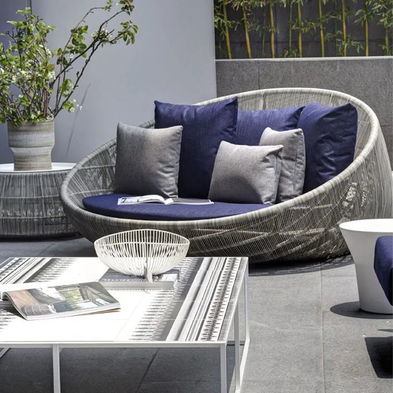 Relaxing on a comfortable outdoor garden round bed chair.