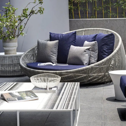 Relaxing on a comfortable outdoor garden round bed chair.
