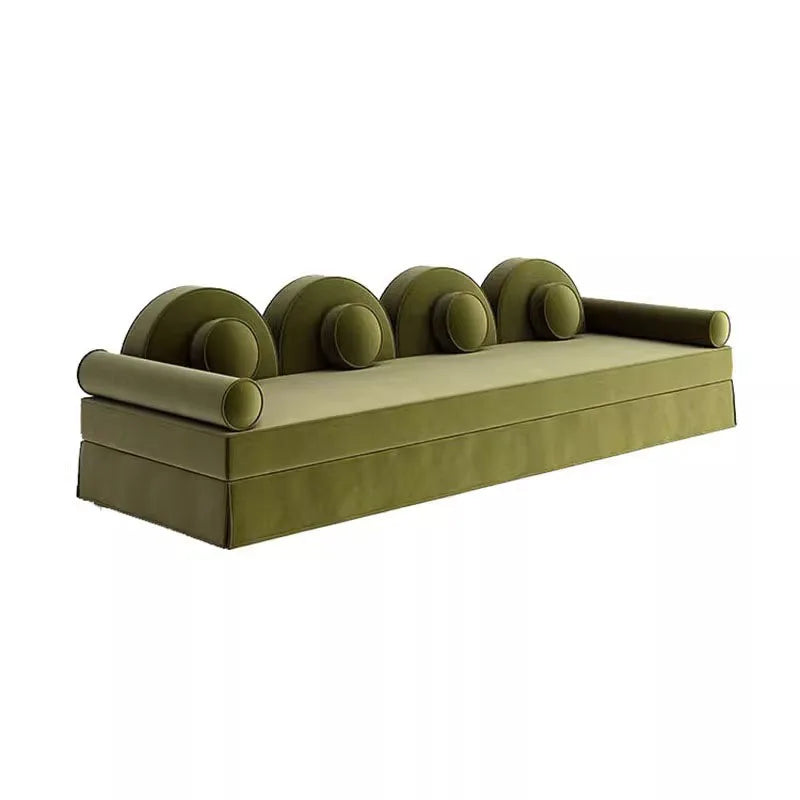 Green sofa with circular armrests on a white background