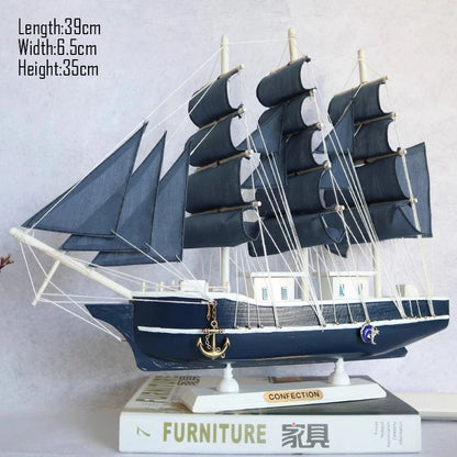 Model ship with blue sails on a white surface