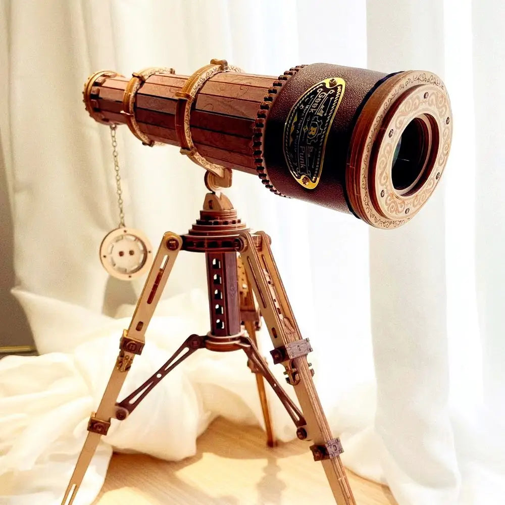 Vintage-style telescope on a stand against a white curtain background