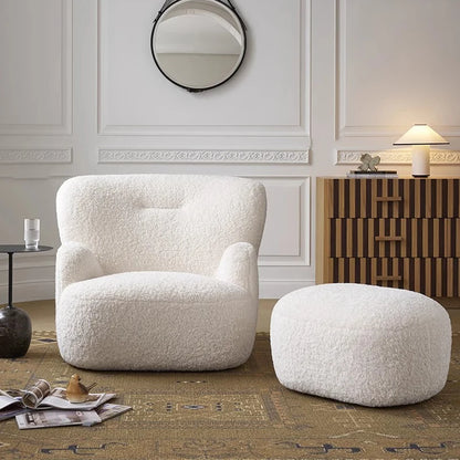 White textured armchair and ottoman in a stylish room with decorative elements.