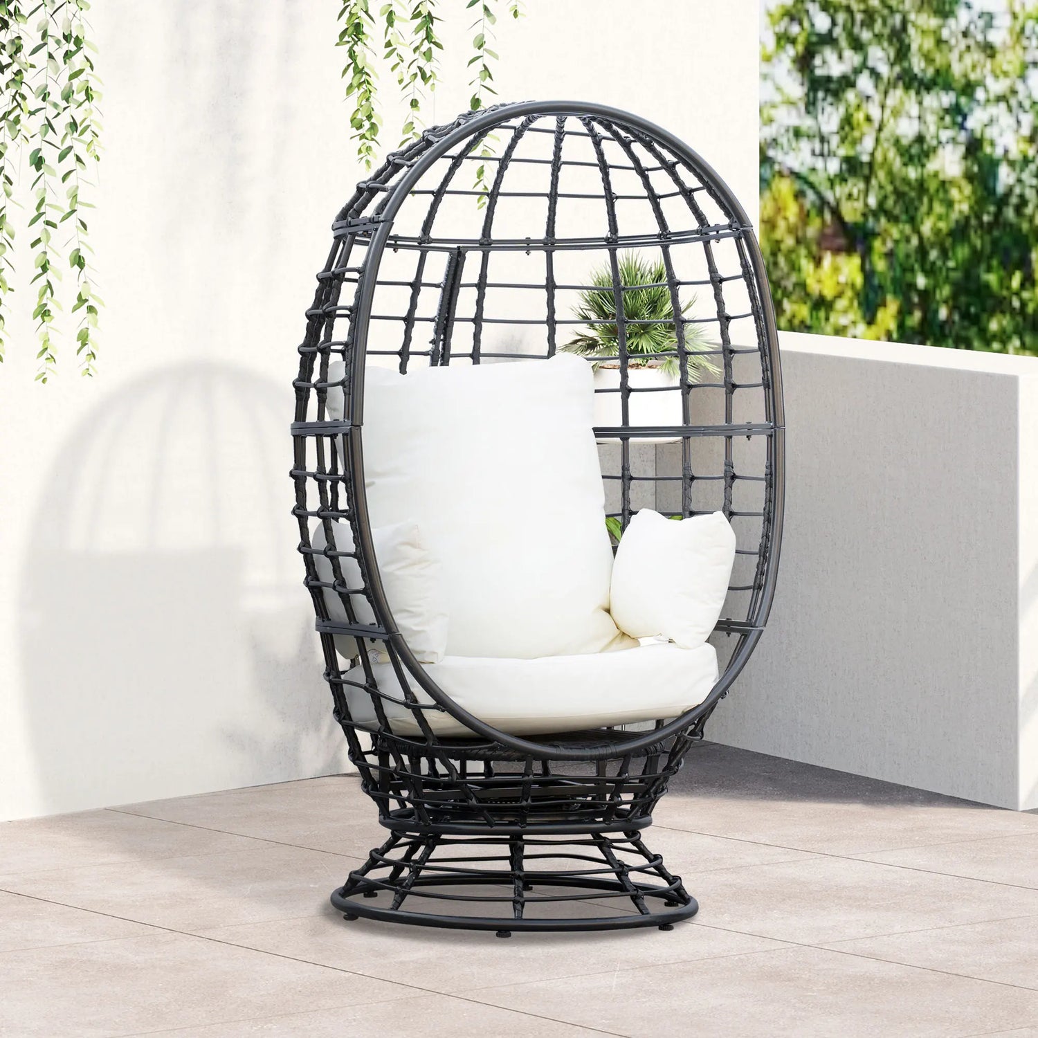 Black egg-shaped chair with white cushions on a wooden deck