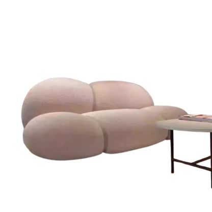 Modern pink sofa with a side table on a white background
