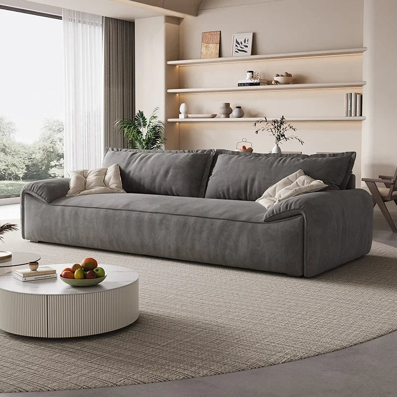 Gray sofa in a modern living room with a coffee table and decorative items.