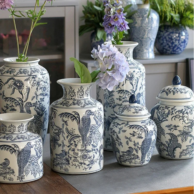 Collection of blue and white patterned ceramic jars and vases on a surface.