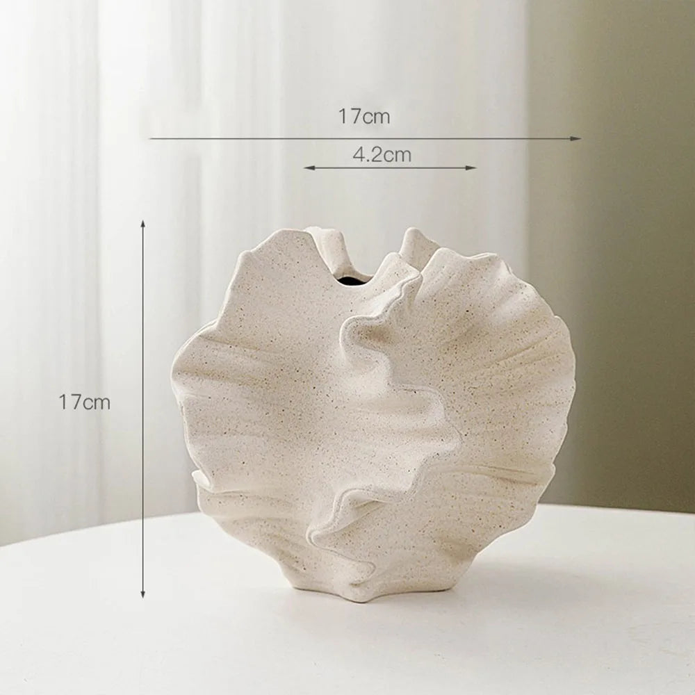 White ceramic shell-shaped vase with measurements on a white background