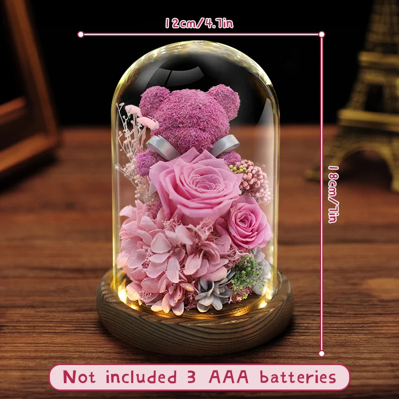 Preserved flower bear displayed on a bedside table.
