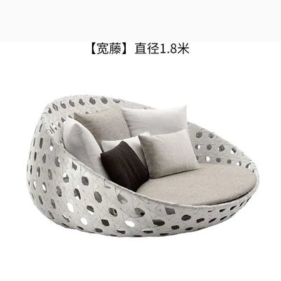 Stylish outdoor garden round bed chair with a side table.