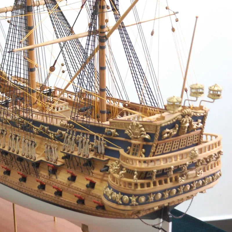 Close-up of a detailed model ship with gold and blue accents.