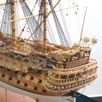 Close-up of a detailed model ship with gold and blue accents.