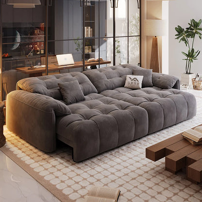 Gray sectional sofa in a modern living room with a coffee table and decor items.