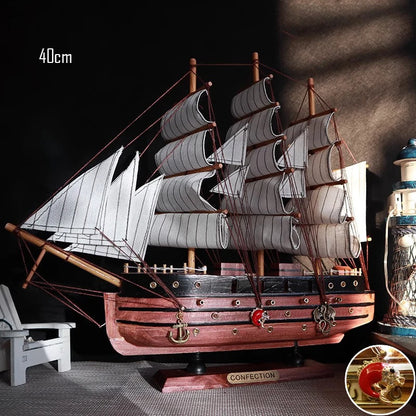 Wooden model ship with detailed sails on a dark background
