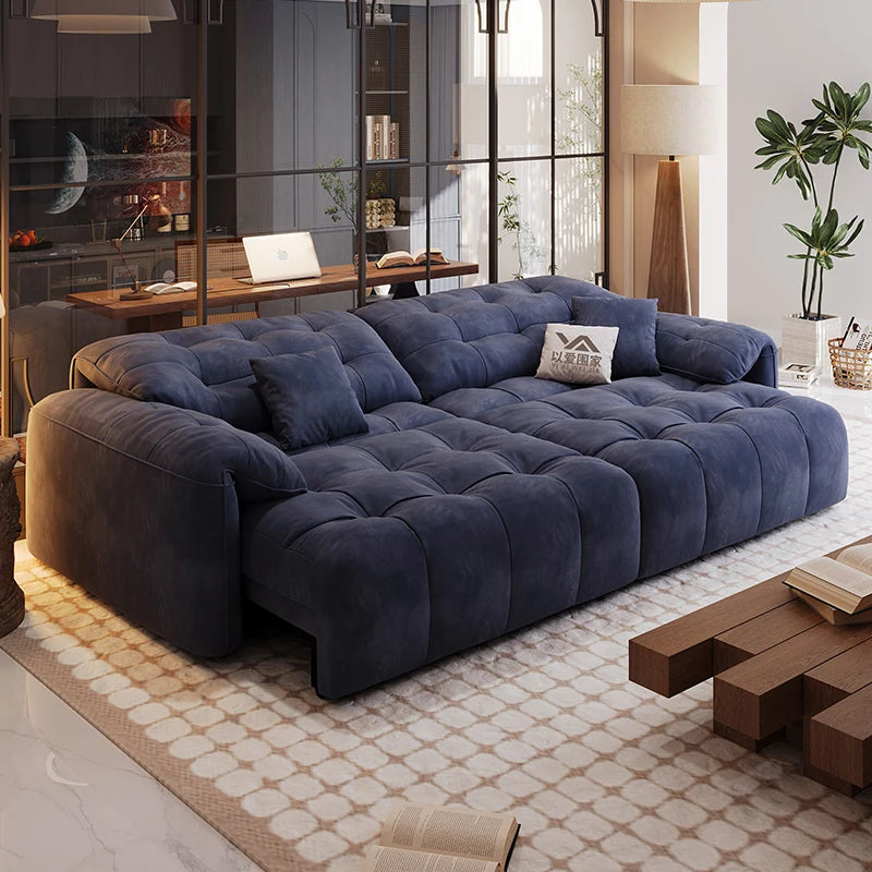 Blue sectional sofa in a modern living room with a coffee table and decorative items.