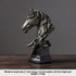 Bronze horse head sculpture on a dark background