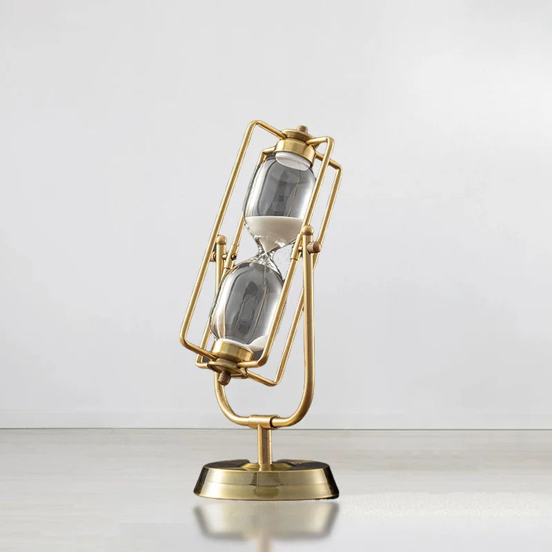 Gold hourglass-shaped clock on a white background