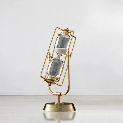 Gold hourglass-shaped clock on a white background