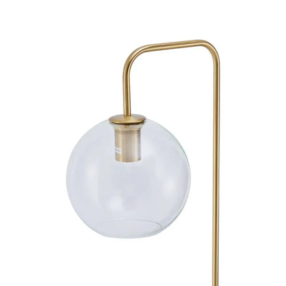 Modern table lamp with a gold base and white glass shade on a white background