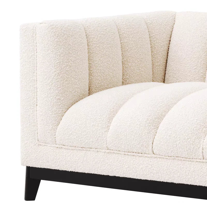 Close-up of a textured beige sofa with black legs on a white background