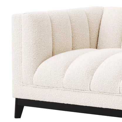 Close-up of a textured beige sofa with black legs on a white background