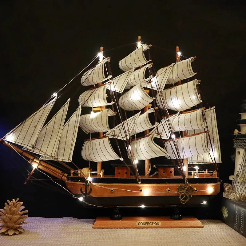 Model ship with lit sails on a dark background