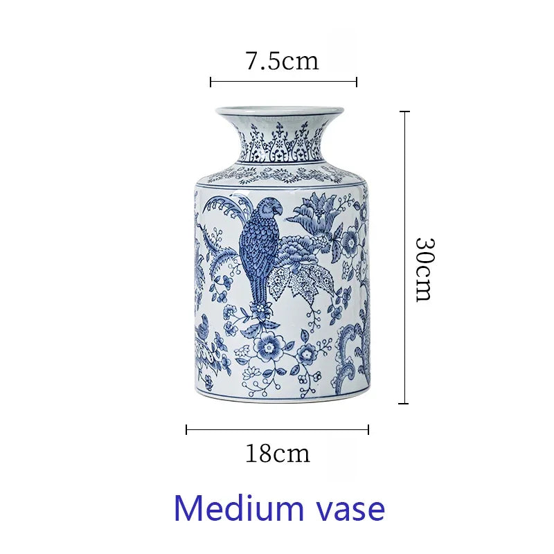 Blue and white vase with floral and parrot design, shown with measurements on a white background.